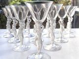 six wine glasses sitting on a table outside