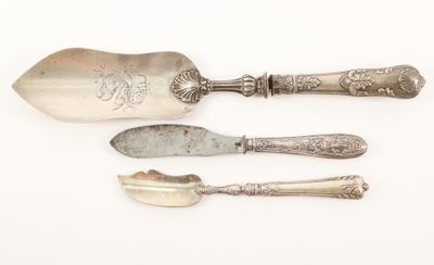 three silver spoons and a fork on a white surface