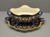 an image of a blue and yellow bowl and saucer on a table
