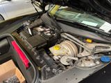 the engine of a car with its hood open in a garage