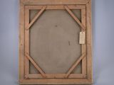 an old wooden frame with a tag hanging on it