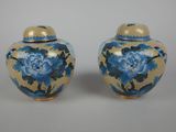 pair of blue and gold vases with blue flowers on them