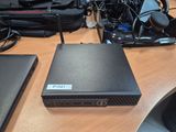 a black box sitting on top of a desk next to a laptop