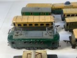 several toy trains are lined up in a row on a white surface