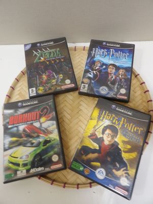three harry potter dvd ' s are sitting on a basket on a table