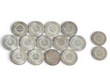 several coins are arranged in a row on a white surface