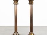 a pair of brass candlesticks on a white background