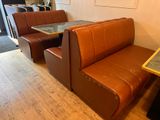 a booth with a table and a bench in the corner
