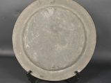 a plate that is sitting on a stand on a table