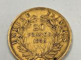 a close up of a gold coin on a white surface