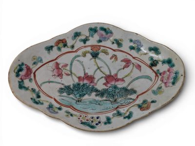 a plate with flowers and leaves on it on a white surface