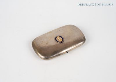 a silver cigarette case with a gold emblem on it