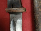 a close up of a knife on a red surface