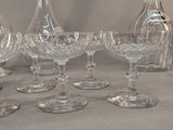 a group of wine glasses and a decanter on a table