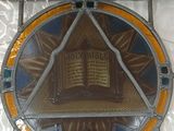 a stained glass window with a book on it