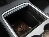a cup holder in the center of a car ' s dashboard