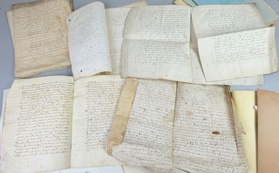 some old papers are sitting on top of a table next to a pair of scissors