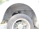 a white truck that has a flat tire on the side of it
