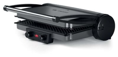 un gros plan d'un barbecue électrique posé sur une surface blanche