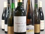 several bottles of wine are lined up in a row on a table