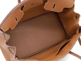 the small leather tote bag is open and ready to be carried