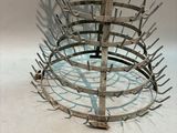 a metal rack that has a bunch of nails in it