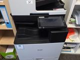 a printer sitting on top of a filing cabinet in a room