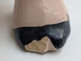 a close up of a vase with a piece of paper sticking out of it