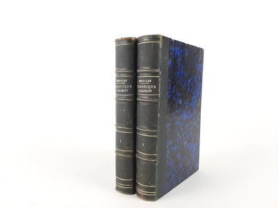 two books sitting on top of each other on a white surface