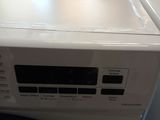 an image of a white washing machine sitting on top of a counter