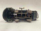 a small model of a sewing machine on a white surface
