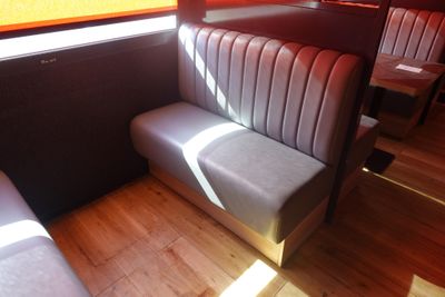 a booth with a bench and a table in it