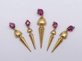 a set of three gold and pink stone spike earrings