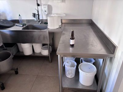 a kitchen with a sink and a counter with a bottle on it