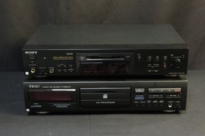 two sony cd players are stacked on top of each other