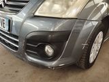 a picture of a car that has been dented and is parked in a garage