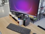 a desk with a keyboard, mouse, and monitor on it