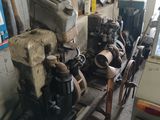 a small engine sitting on a cart in a garage