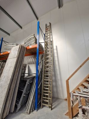 a ladder that is leaning against a wall in a warehouse