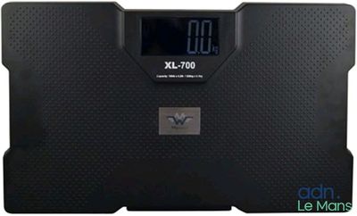 a close up of a bathroom scale with a clock on it