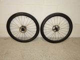 pair of black rims with spokes and spokes on a wall