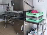 a kitchen with a sink, stove, dishwasher and other items on the counter
