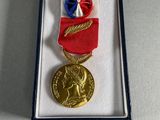an image of a medal in a box with a ribbon around it
