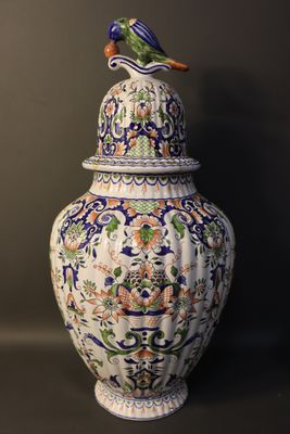 a large vase with a bird on top of it