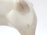 a close up of a figurine of a white cat