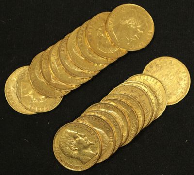 a close up of a pile of gold coins on a black surface