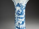 blue and white porcelain vase with a landscape scene on it