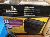 a box of paper shredder next to a phone on the floor