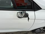 a white car with an electric charger attached to it ' s side