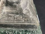 statue of a man with a beard on a green marble base